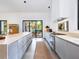 Eat-in kitchen with island, stainless steel appliances, and sliding glass doors at 1331 Quail Dr, Sarasota, FL 34231