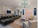 Spacious living area with comfortable seating and a statement chandelier at 1331 Quail Dr, Sarasota, FL 34231