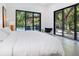 Spacious bedroom with a white duvet and sliding doors to the pool at 1331 Quail Dr, Sarasota, FL 34231