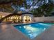 Tranquil rectangular pool surrounded by patio and lush greenery at 1331 Quail Dr, Sarasota, FL 34231