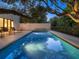 Relaxing pool area with lighting and large tree overhead at 1331 Quail Dr, Sarasota, FL 34231