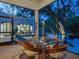Bright sunroom with glass walls and rattan dining set at 1331 Quail Dr, Sarasota, FL 34231