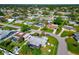 Aerial view of a residential neighborhood with single-Gathering homes and lush green yards at 138 Paddington Rd, Venice, FL 34293