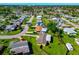 Aerial view of a residential area featuring houses with well-maintained lawns at 138 Paddington Rd, Venice, FL 34293