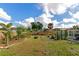 Spacious backyard with firepit, garden, pergola, and lush landscaping at 138 Paddington Rd, Venice, FL 34293