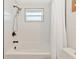 Clean bathroom with a bathtub, shower, and white tile at 138 Paddington Rd, Venice, FL 34293