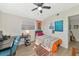 Well-lit bedroom with a twin bed, desk, and guitar at 138 Paddington Rd, Venice, FL 34293