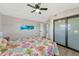Bright bedroom with a queen bed and sliding glass closet doors at 138 Paddington Rd, Venice, FL 34293