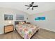 Bedroom with a queen bed, nightstand, and ceiling fan at 138 Paddington Rd, Venice, FL 34293