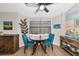 Bright breakfast nook with a round table and two teal chairs at 138 Paddington Rd, Venice, FL 34293