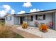 Updated home exterior, featuring a landscaped front yard with seating at 138 Paddington Rd, Venice, FL 34293