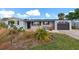 Charming ranch home with landscaped yard and gray exterior at 138 Paddington Rd, Venice, FL 34293