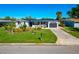 Single story home with metal roof and manicured lawn at 138 Paddington Rd, Venice, FL 34293