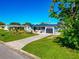 Single story home with metal roof and manicured lawn at 138 Paddington Rd, Venice, FL 34293