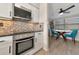 Modern kitchen with stainless steel appliances and mosaic backsplash at 138 Paddington Rd, Venice, FL 34293