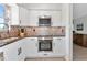 Updated kitchen with white shaker cabinets and granite countertops at 138 Paddington Rd, Venice, FL 34293