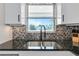 Modern kitchen sink with black faucet and granite countertop at 138 Paddington Rd, Venice, FL 34293