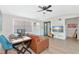 Bright living room with hardwood floors, comfortable seating, and workspace at 138 Paddington Rd, Venice, FL 34293