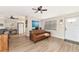Living room with brown leather sofa and ceiling fan at 138 Paddington Rd, Venice, FL 34293