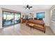 Living area featuring hardwood floors, sliding doors to patio, and modern furniture at 138 Paddington Rd, Venice, FL 34293