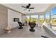 Bright sunroom with tiled floor, wicker chairs, and fireplace at 138 Paddington Rd, Venice, FL 34293