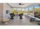 Relaxing sunroom with wicker chairs and an electric fireplace at 138 Paddington Rd, Venice, FL 34293