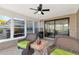 Spacious sunroom with sliding glass doors and wicker chairs at 138 Paddington Rd, Venice, FL 34293