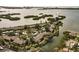 Aerial view of waterfront community nestled amongst lush landscaping at 1519 Pelican Point Dr # 292, Sarasota, FL 34231