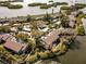 Aerial view of waterfront community with lush landscaping and private boat slips at 1519 Pelican Point Dr # 292, Sarasota, FL 34231