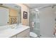 Bathroom with white cabinets, a decorative mirror and glass shower stall at 1519 Pelican Point Dr # 292, Sarasota, FL 34231
