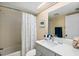 Bright bathroom featuring a shower/tub combo, coordinating accessories, and updated vanity with a modern mirror at 1519 Pelican Point Dr # 292, Sarasota, FL 34231