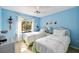 Bright bedroom with two beds, a window and cool-blue paint at 1519 Pelican Point Dr # 292, Sarasota, FL 34231