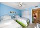 Twin bedroom showcasing blue walls, ample closet space, and neat decor with a charming, organized interior at 1519 Pelican Point Dr # 292, Sarasota, FL 34231