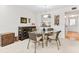 Dining room with glass table and access to kitchen and front door at 1519 Pelican Point Dr # 292, Sarasota, FL 34231