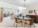 Dining room with natural lighting, glass top table and view into living room at 1519 Pelican Point Dr # 292, Sarasota, FL 34231