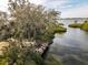 Aerial view of a wooden dock extending into the water at 1519 Pelican Point Dr # 292, Sarasota, FL 34231