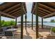 A covered wooden dock featuring waterfront views, seating, and access to the beautiful water at 1519 Pelican Point Dr # 292, Sarasota, FL 34231