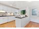 Bright kitchen with white cabinetry, stainless appliances, and granite countertops at 1519 Pelican Point Dr # 292, Sarasota, FL 34231