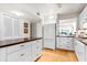 Kitchen with white cabinets, granite countertops, a refrigerator, and wood flooring at 1519 Pelican Point Dr # 292, Sarasota, FL 34231