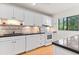 Beautiful kitchen with white appliances and a window to bring in natural light at 1519 Pelican Point Dr # 292, Sarasota, FL 34231
