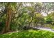 Wooden footbridge over a tranquil waterway, surrounded by lush vegetation at 1519 Pelican Point Dr # 292, Sarasota, FL 34231