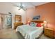 This main bedroom features a ceiling fan and views into the main bath at 1519 Pelican Point Dr # 292, Sarasota, FL 34231