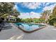 Community pool surrounded by lounge chairs, umbrellas, and lush greenery, perfect for relaxation at 1519 Pelican Point Dr # 292, Sarasota, FL 34231