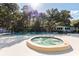 Community pool and spa surrounded by mature trees, offering a relaxing retreat with plenty of space at 1519 Pelican Point Dr # 292, Sarasota, FL 34231