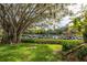 Mature tree provides shade over manicured lawn and marina view at 1519 Pelican Point Dr # 292, Sarasota, FL 34231