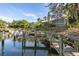 Waterfront property showcasing docks, a boat, and beautiful views in a wooded community at 1519 Pelican Point Dr # 292, Sarasota, FL 34231