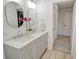 Bathroom with double sink vanity, round mirrors, and access to closet at 2155 Harbourside Dr # 804, Longboat Key, FL 34228