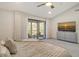 Bright bedroom with private balcony and view, carpet floor, and ceiling fan at 2155 Harbourside Dr # 804, Longboat Key, FL 34228
