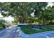 View of the Bay Isles Beach Club entrance, featuring lush landscaping and a private gate at 2155 Harbourside Dr # 804, Longboat Key, FL 34228