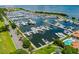 Aerial view of a marina filled with boats and yachts docked in a serene bay setting at 2155 Harbourside Dr # 804, Longboat Key, FL 34228